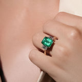 Maria Jose Jewelry Colombian Emerald and Diamond Yellow Gold Ring on model's hand detail view
