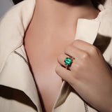 Maria Jose Jewelry Colombian Emerald and Diamond Yellow Gold Ring on model's hand holding coat lapel