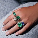 Maria Jose Jewelry Cushion Sapphire Three Stone Diamond Ring on model's hand with other rings