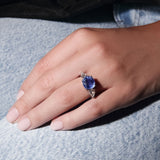Maria Jose Jewelry Cushion Sapphire Three Stone Diamond Ring on model's left hand