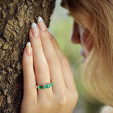 Maria Jose Jewelry East West Three Stone Emerald Ring on model touching tree detailed view