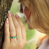 Maria Jose Jewelry East West Three Stone Emerald Ring on model touching tree