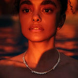 Maria Jose Jewelry Floating Diamond Necklace on model in water with red light shining