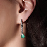 Maria Jose Jewelry Step Cut Drop Emerald and Diamond Earrings on model's left ear
