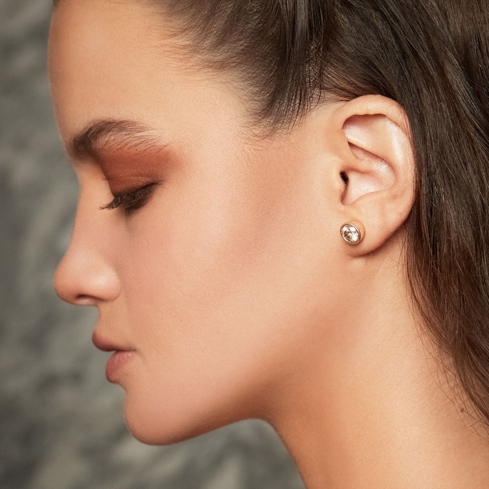A vertical shot of side profile of the model, showing off her earrings, and  hair ornament Stock Photo - Alamy