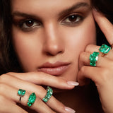 Maria Jose Jewelry Emerald Solitaire Ring on Model Wearing a Collection of Emerald Rings